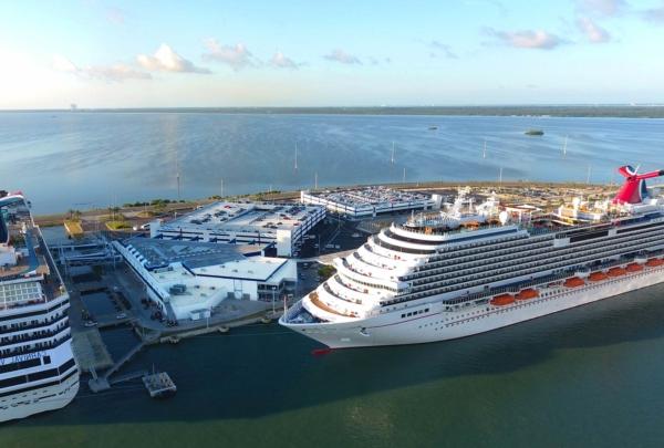 Aerial photo of the Canaveral Port Authority Cruise Terminal 5. Two cruise ships in port at the updated terminal.
